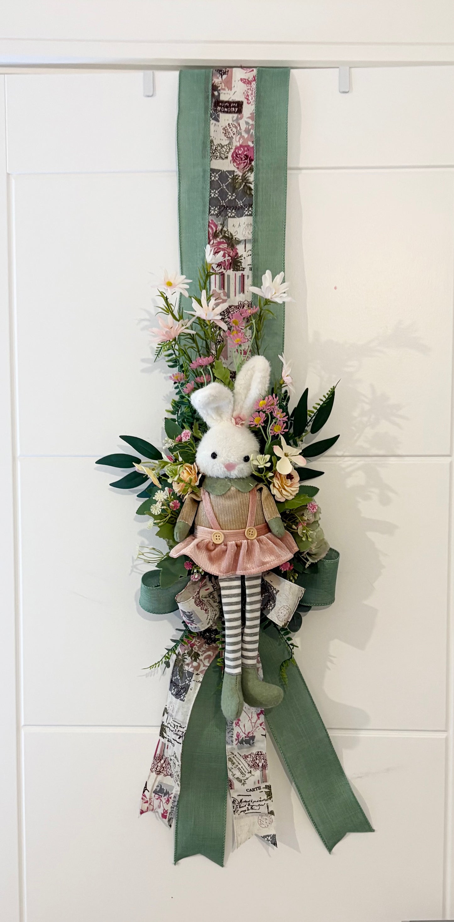Another over the door Easter swag in beautiful greens and pinks with a boy bunny on one side and a girl on the other