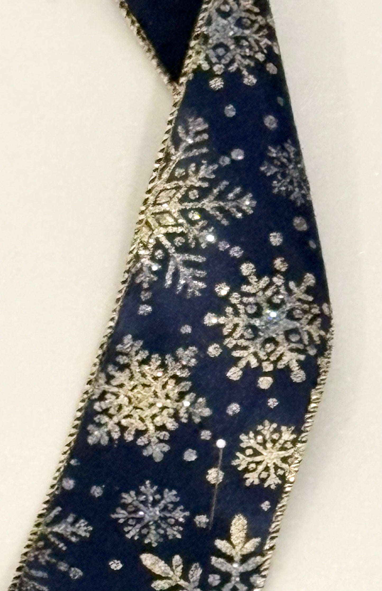 2.5” wired ribbon, navy blue with gold snowflakes