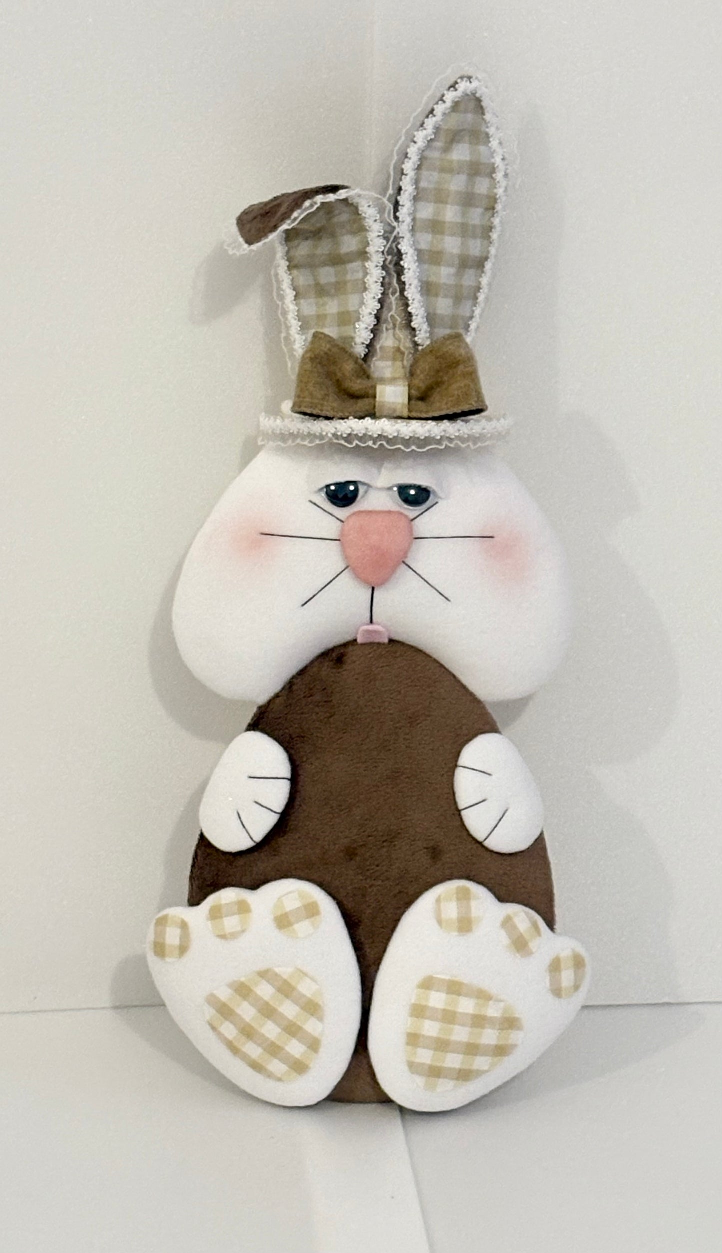 Light chocolate colour ell holding bunny attachment