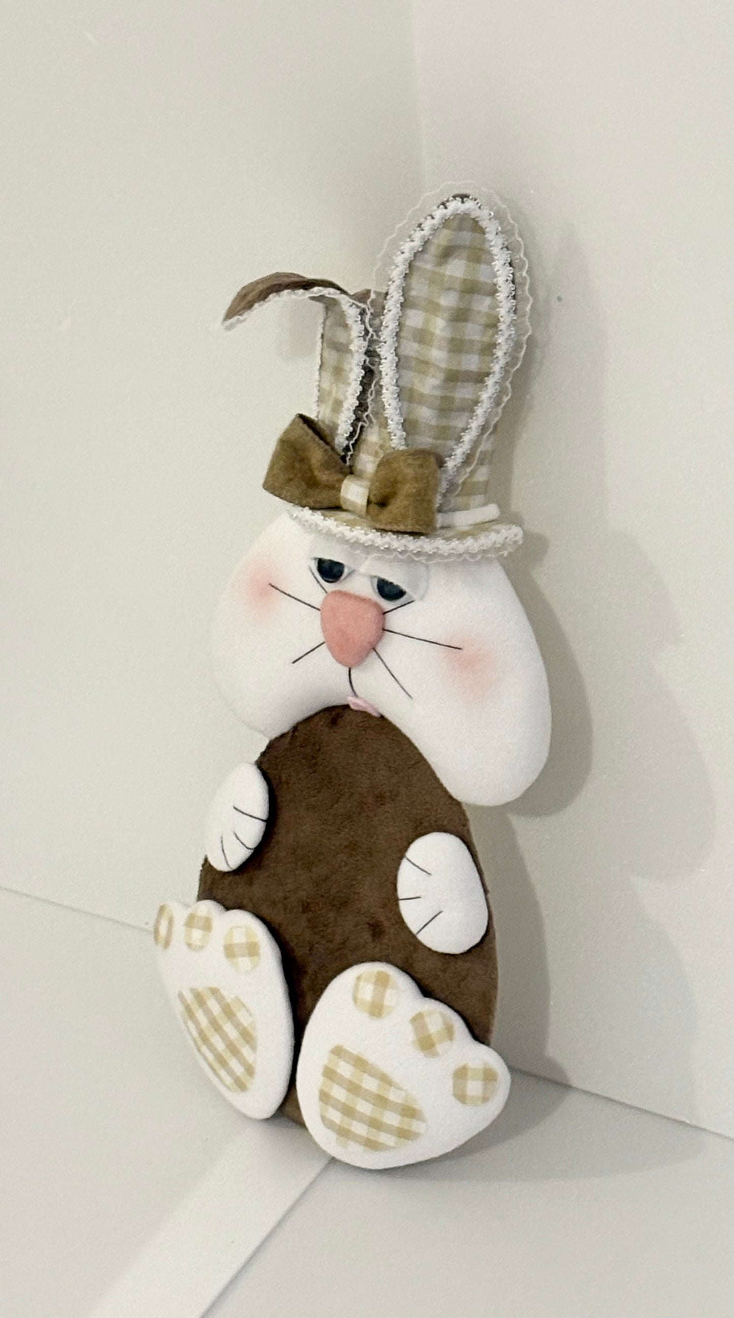 Light chocolate colour ell holding bunny attachment