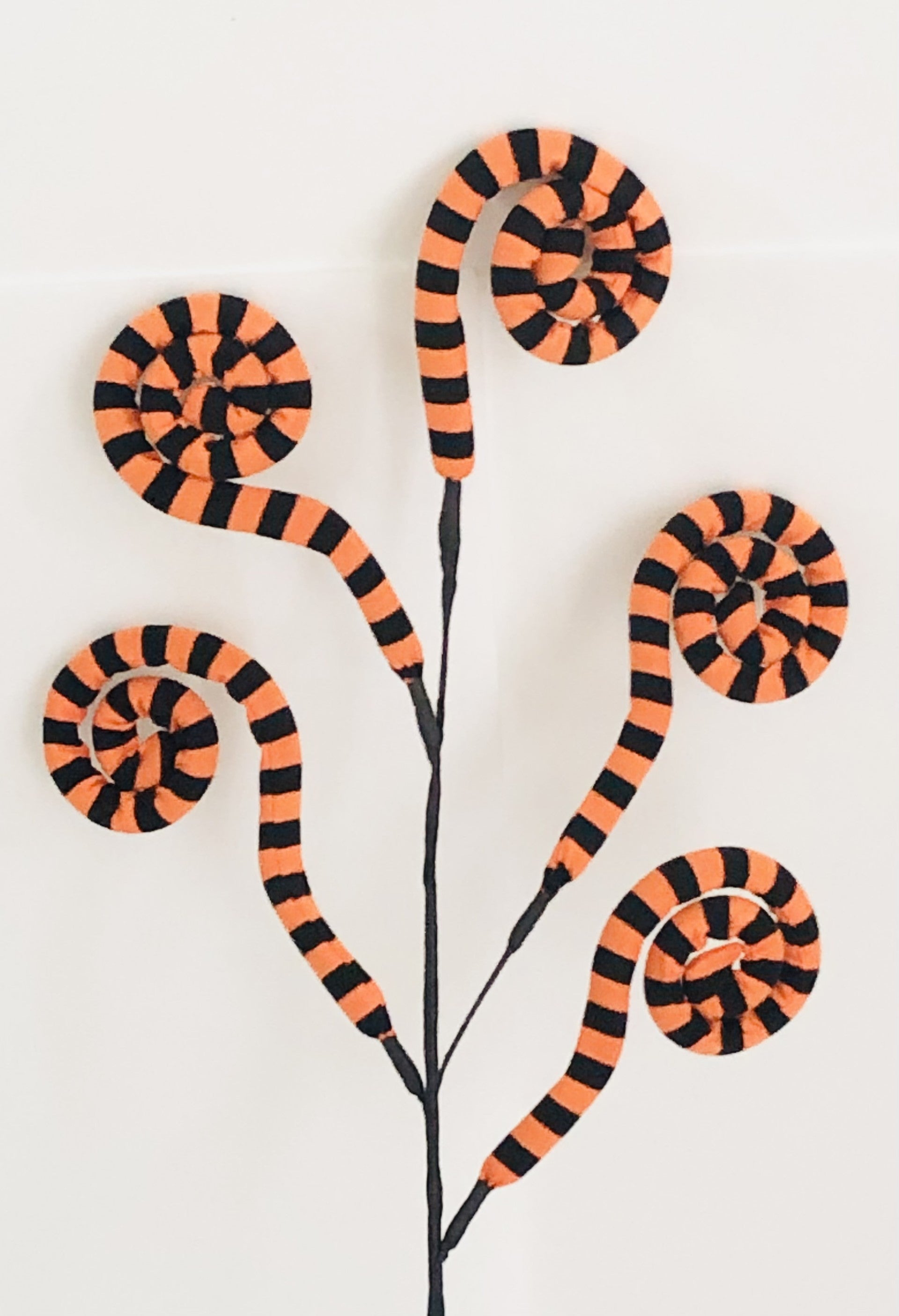 Decorative wall art with orange and black striped snake designs on a white background