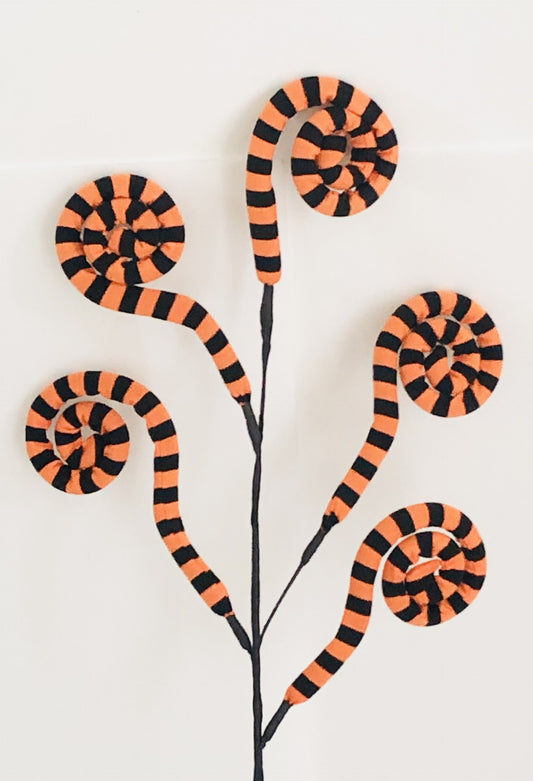 Decorative wall art with orange and black striped snake designs on a white background
