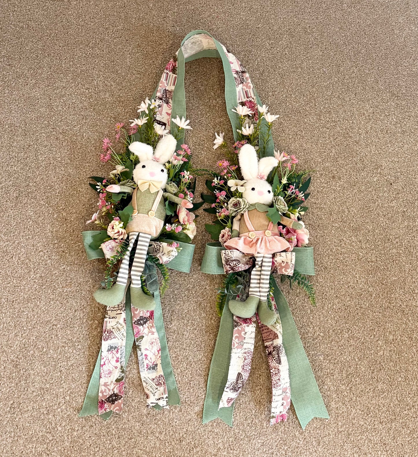 Another over the door Easter swag in beautiful greens and pinks with a boy bunny on one side and a girl on the other