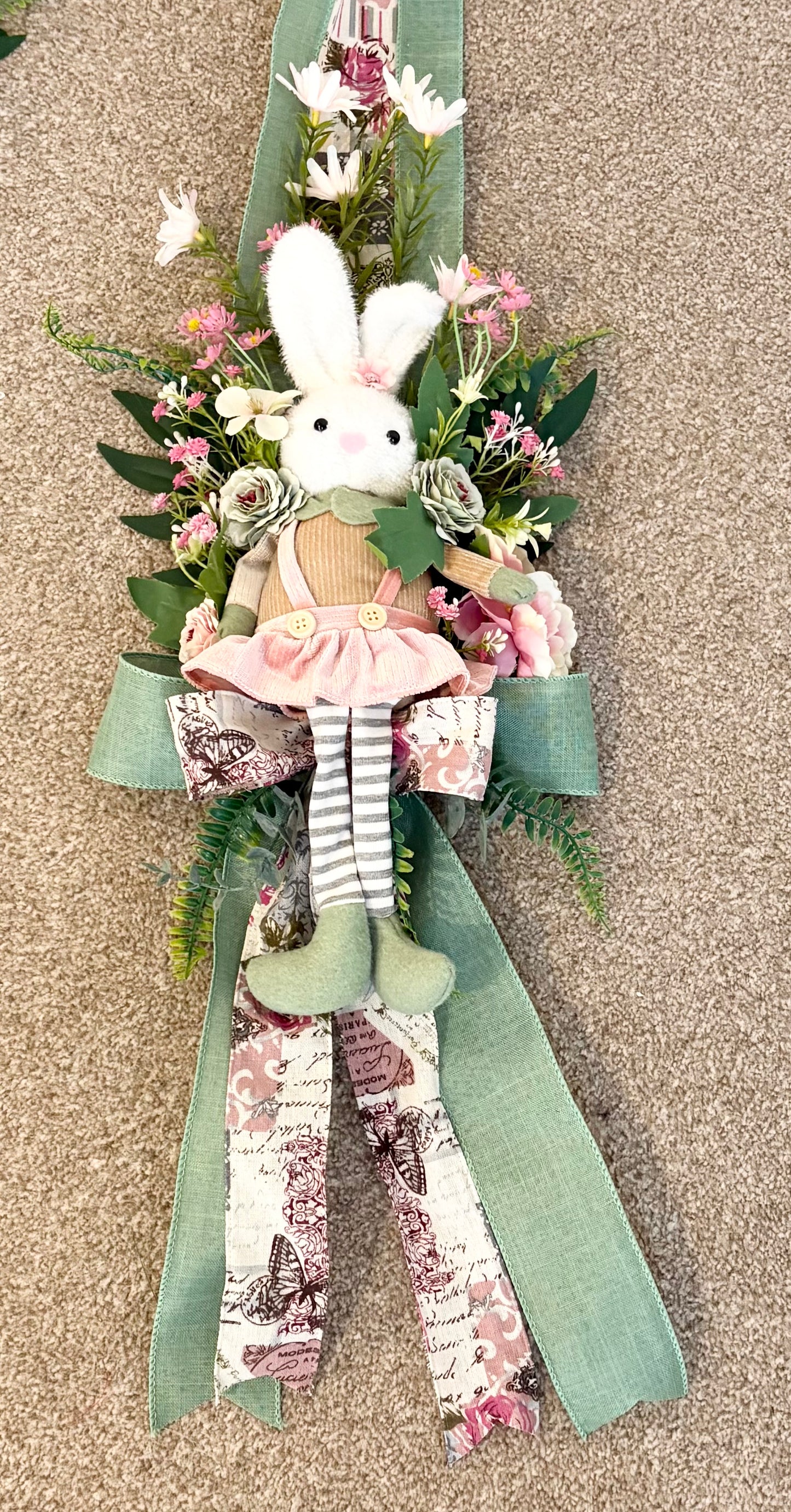 Another over the door Easter swag in beautiful greens and pinks with a boy bunny on one side and a girl on the other