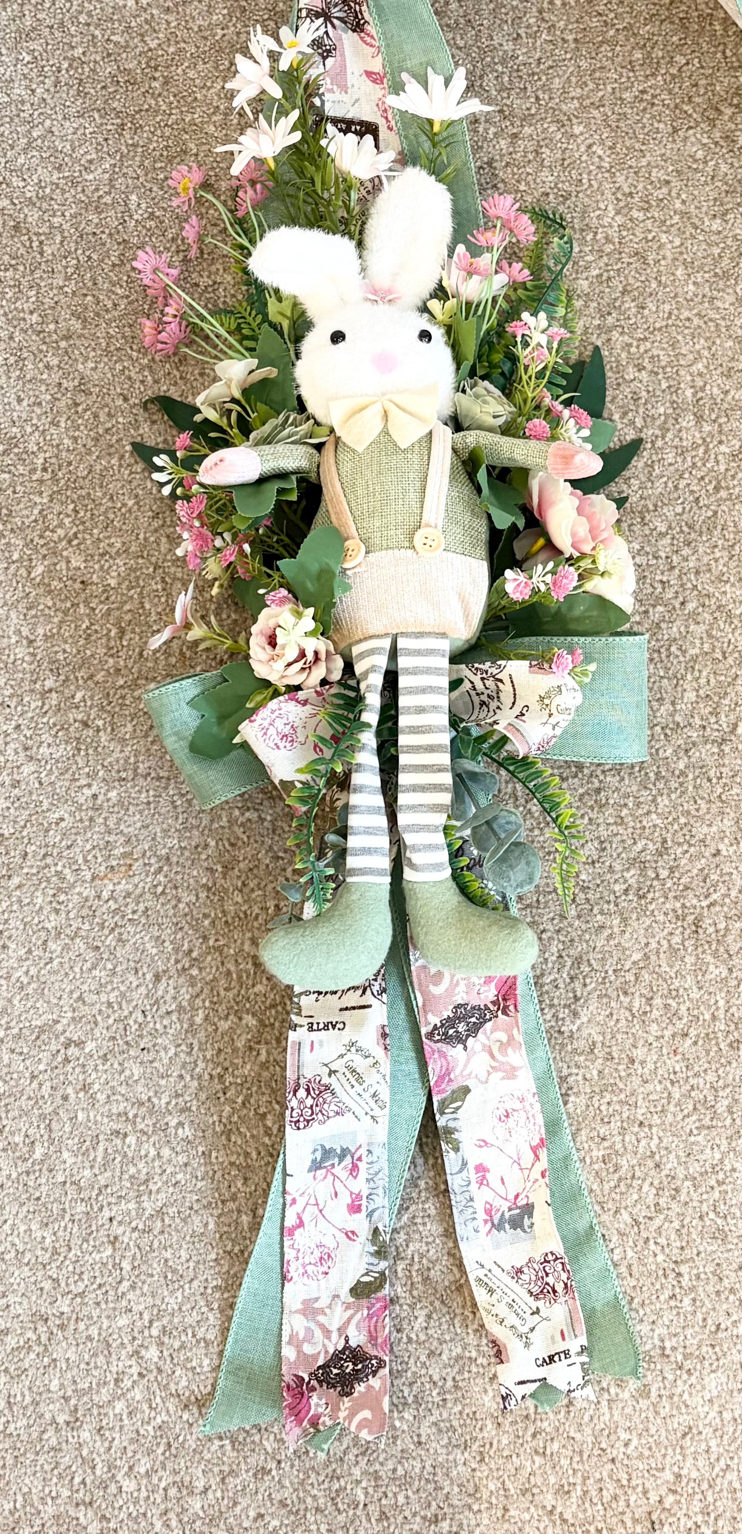 Another over the door Easter swag in beautiful greens and pinks with a boy bunny on one side and a girl on the other
