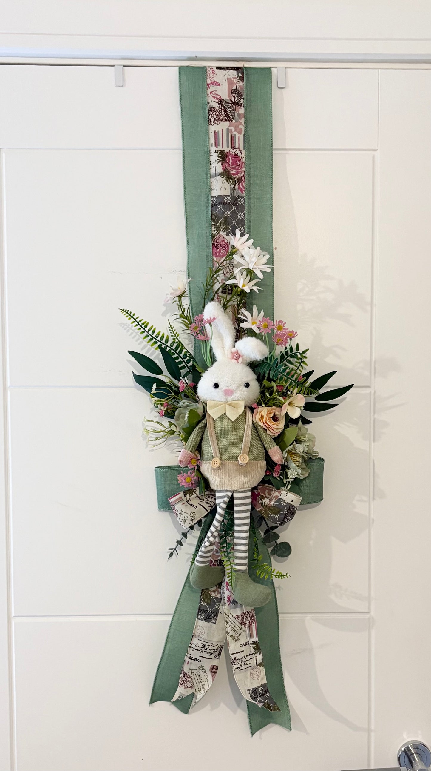 Another over the door Easter swag in beautiful greens and pinks with a boy bunny on one side and a girl on the other